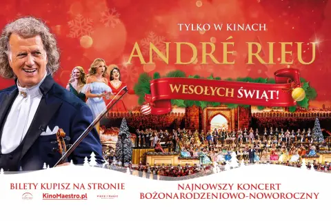 André Rieu w smokingu z skrzypcami, na tle orkiestry i chóru w świątecznej scenografii.