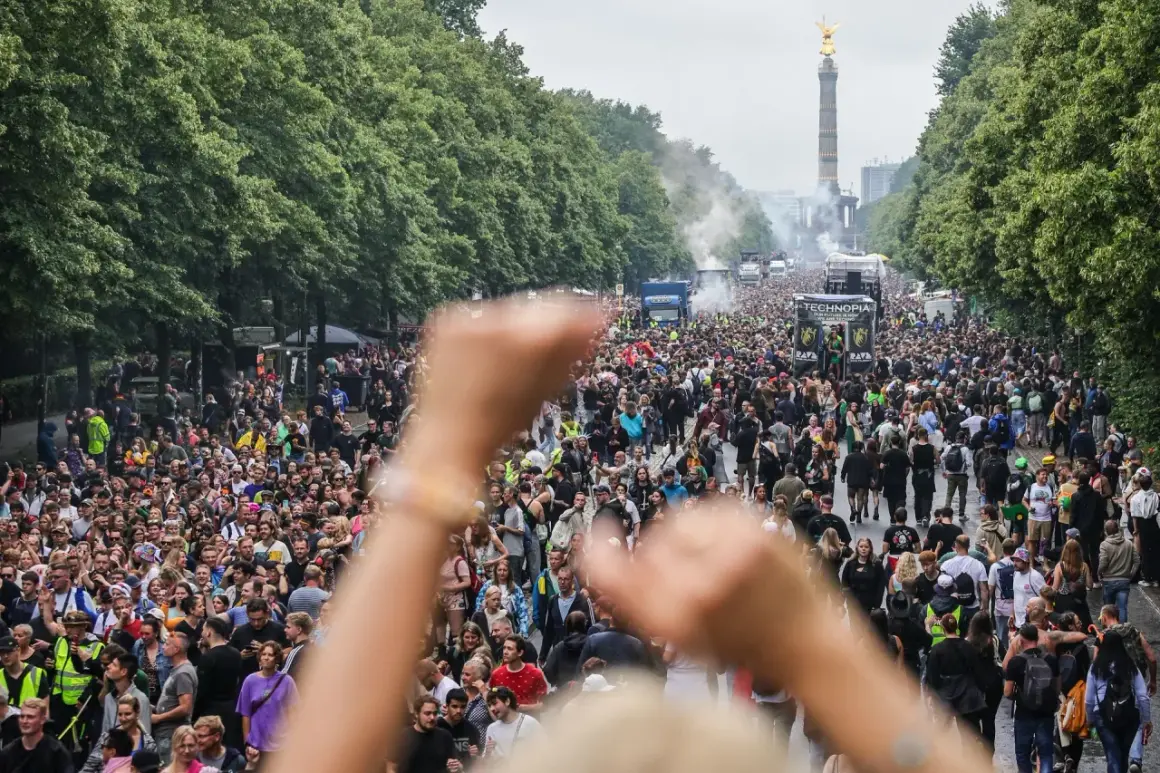 Tłum ludzi na ulicy, ciężarówki z muzyką i Złota Zwycięzca w tle. To jest **love parade**!